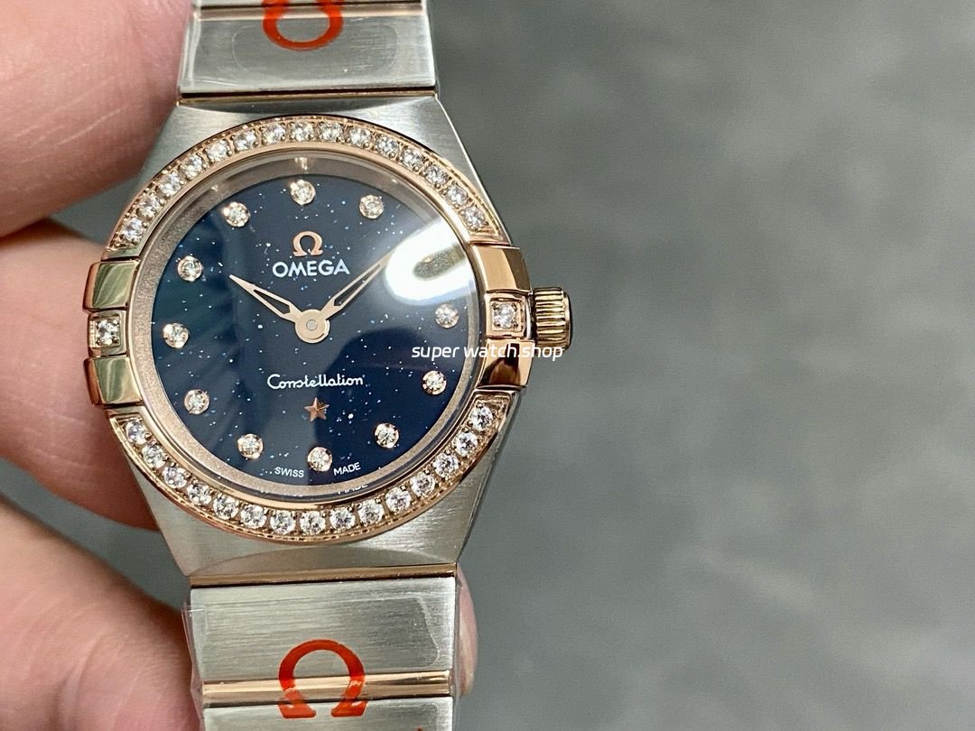 TW-Factory-Omega-Constellation-Quartz-131.25.25.60.53.002-27mm-Roma-3.jpg TW Factory Omega Constellation Quartz 131.25.25.60.53.002 27mm Roman Number Rose Gold Bezel Half Rose Gold Steel Diamond Gypsophila Blue Dial - Image 1